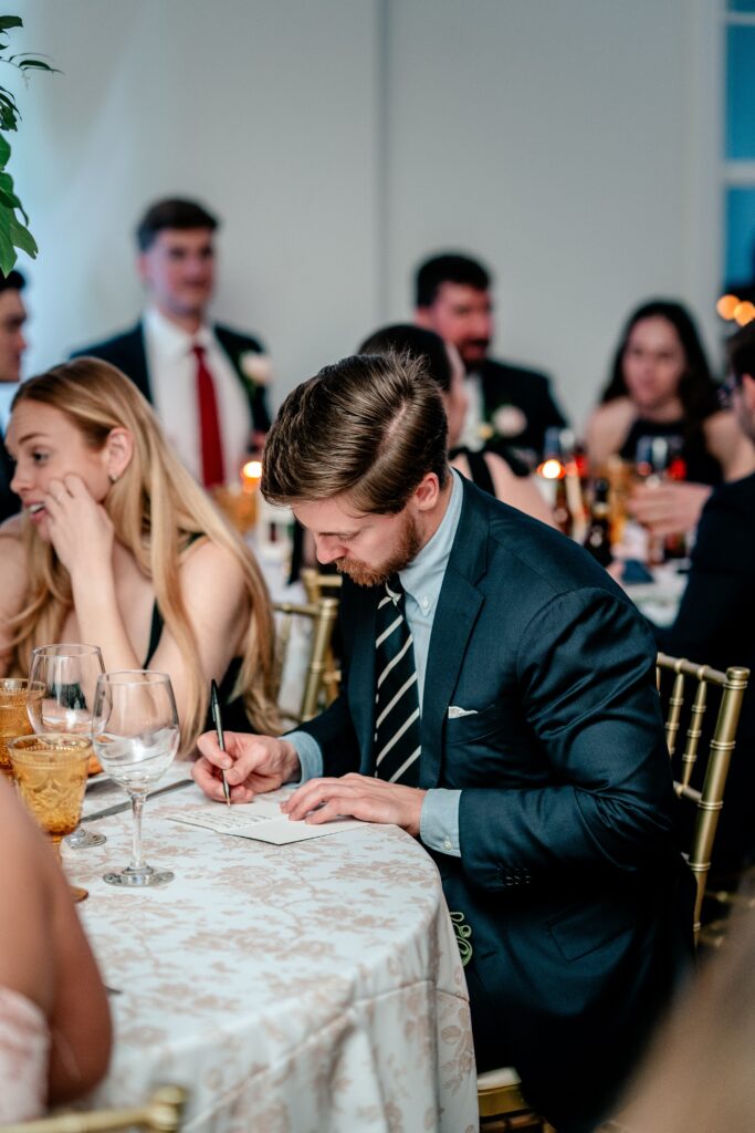Guests writing anniversary cards for the newlyweds during a The Estate at Independence wedding