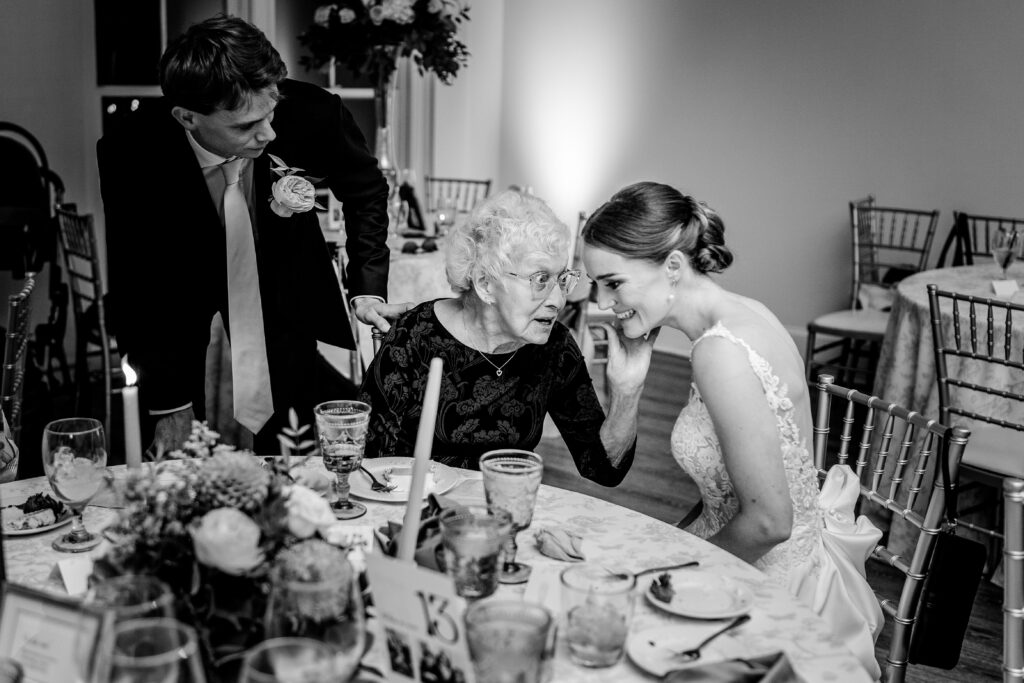 A grandmother chatting with the newlyweds at a The Estate at Independence wedding reception