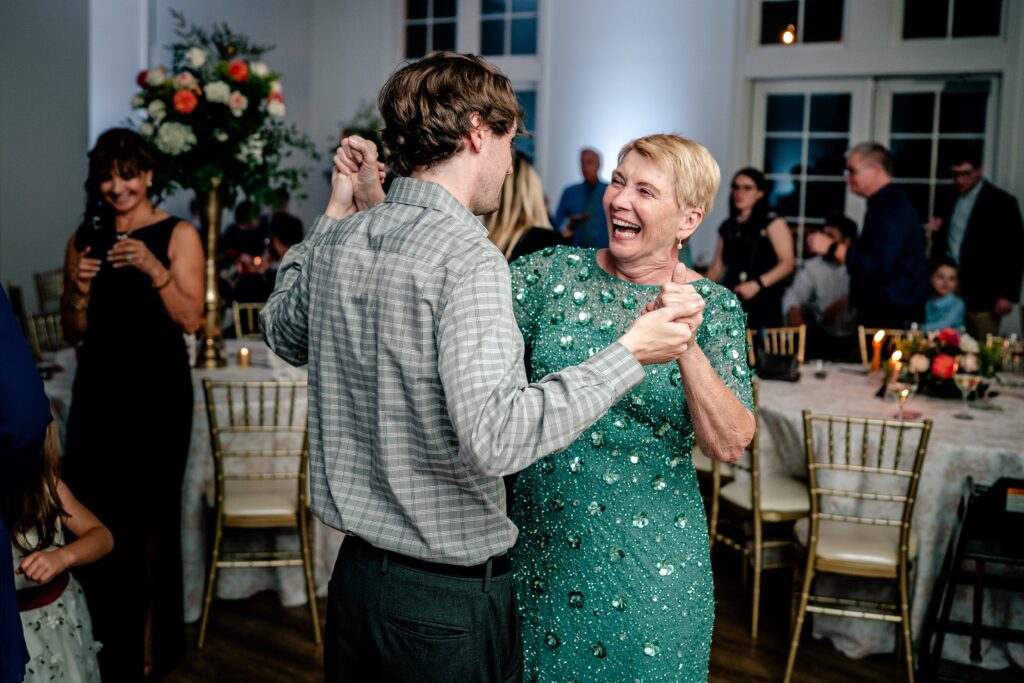 Wedding guests dancing together and laughing