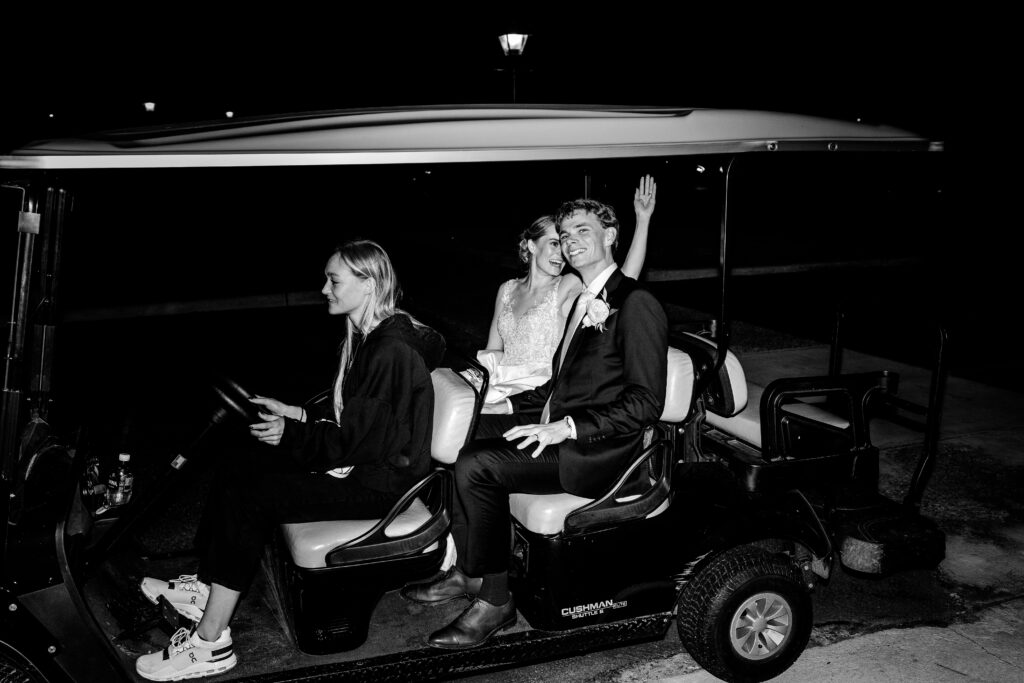 A bride and groom waving goodbye to guests as they leave their The Estate at Independence wedding