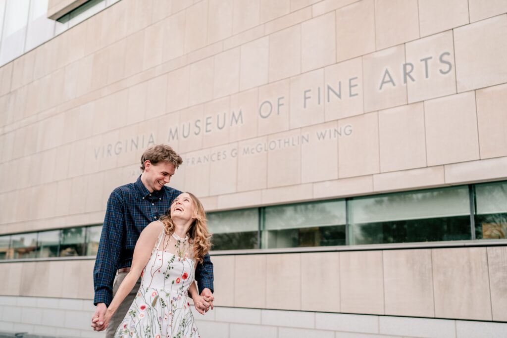 A happy couple in front of the VMFA for Richmond engagement photos