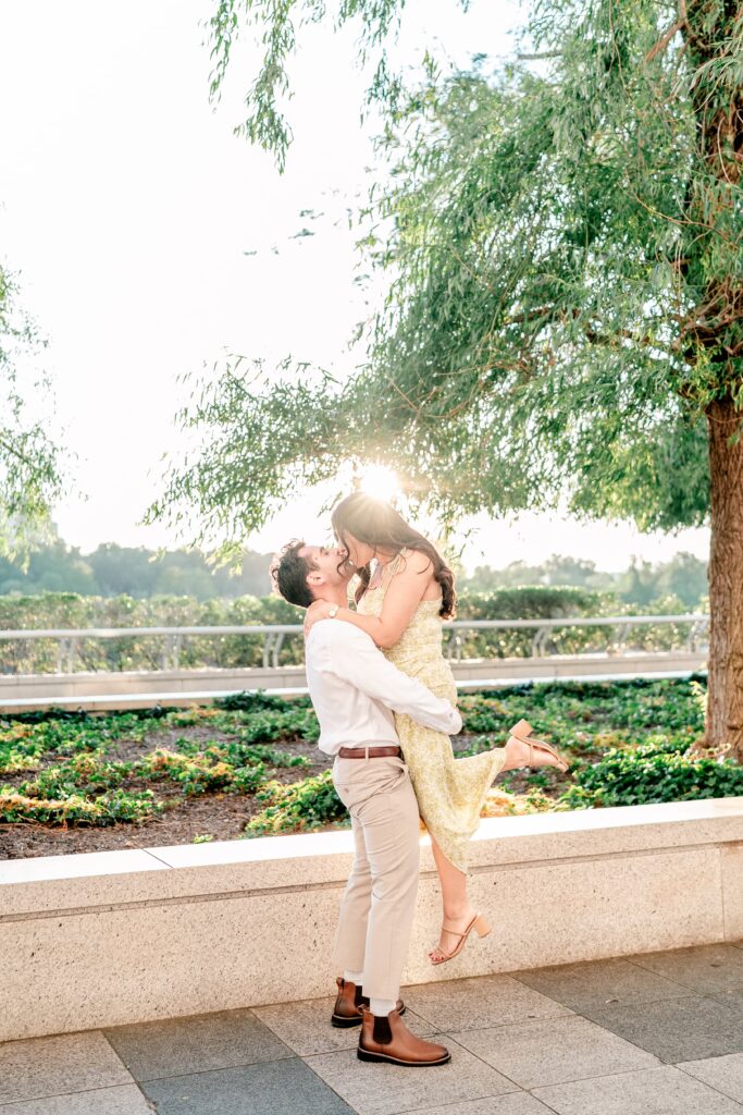 A romantic lift kiss at golden hour for Kennedy Center engagement photos