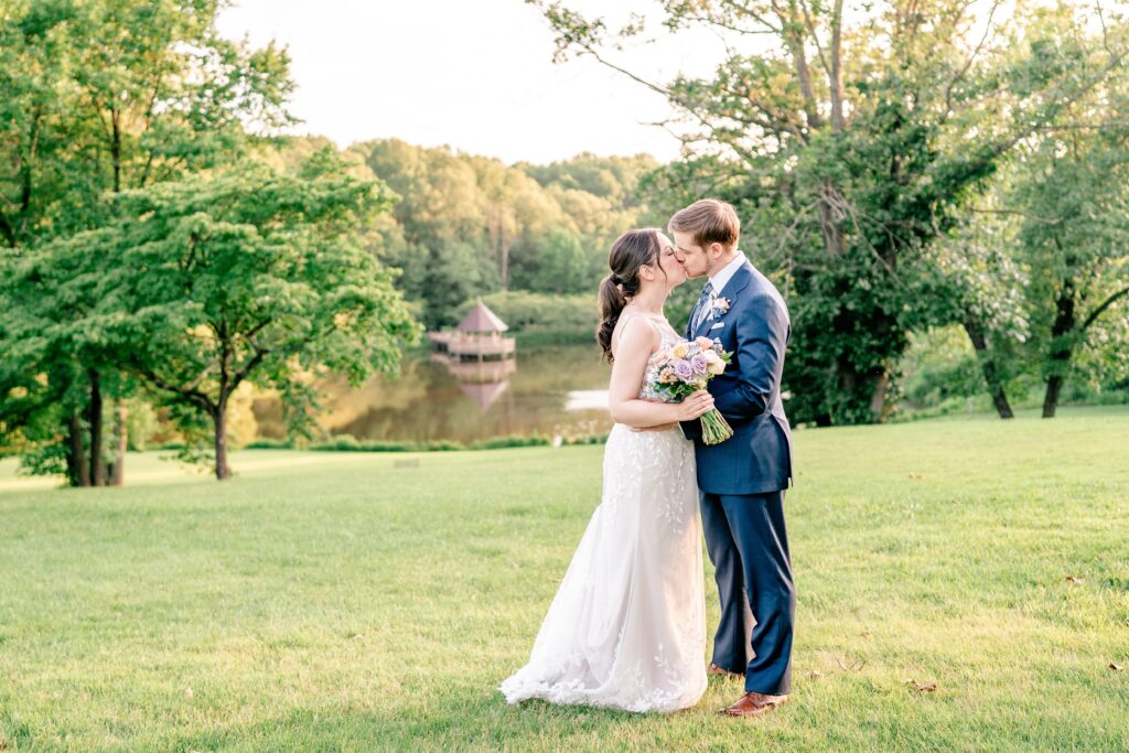 A bride and groom share a kiss at golden hour for their Atrium at Meadowlark wedding