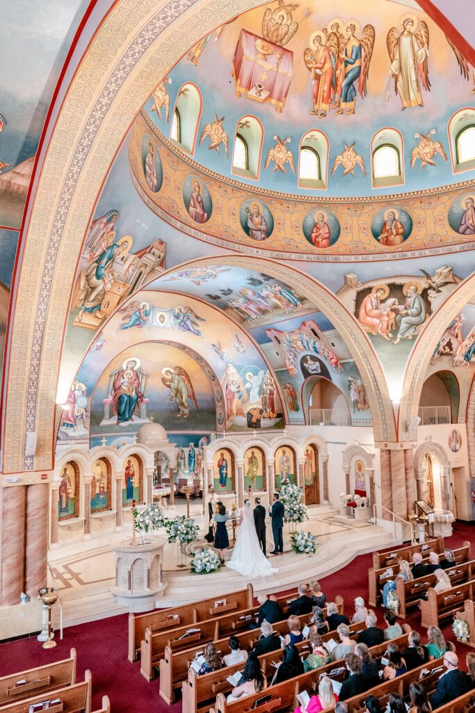 A wide shot of the ceremony by an Orthodox wedding photographer