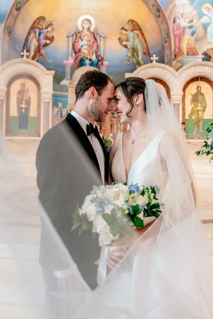 A bride and groom posing for an Orthodox wedding photographer