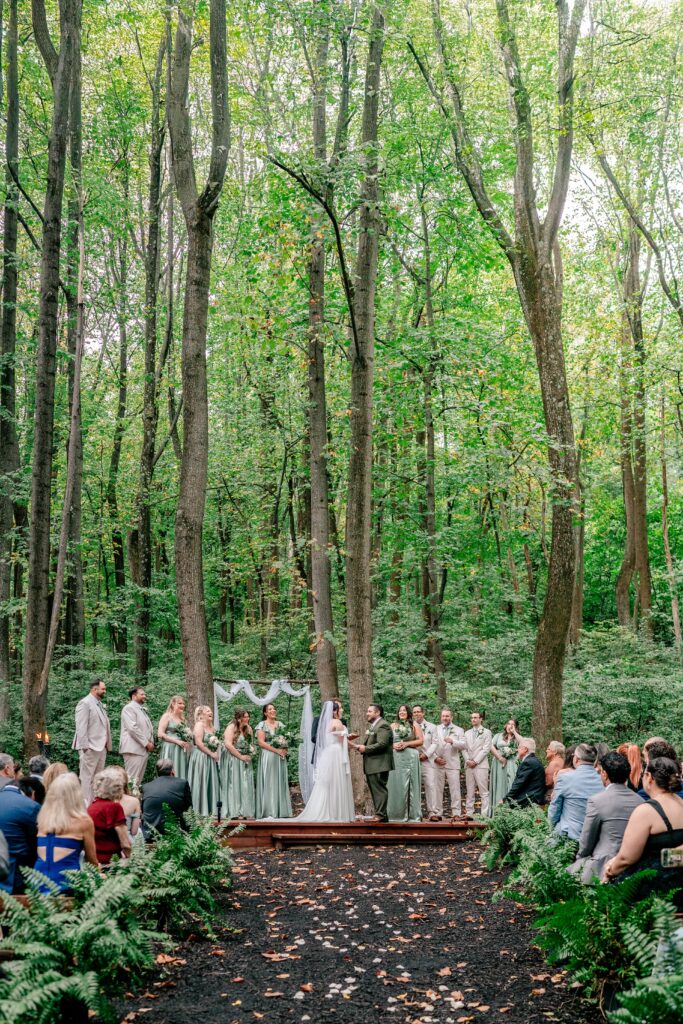 A woodland wedding ceremony at Stone Manor Boutique Inn