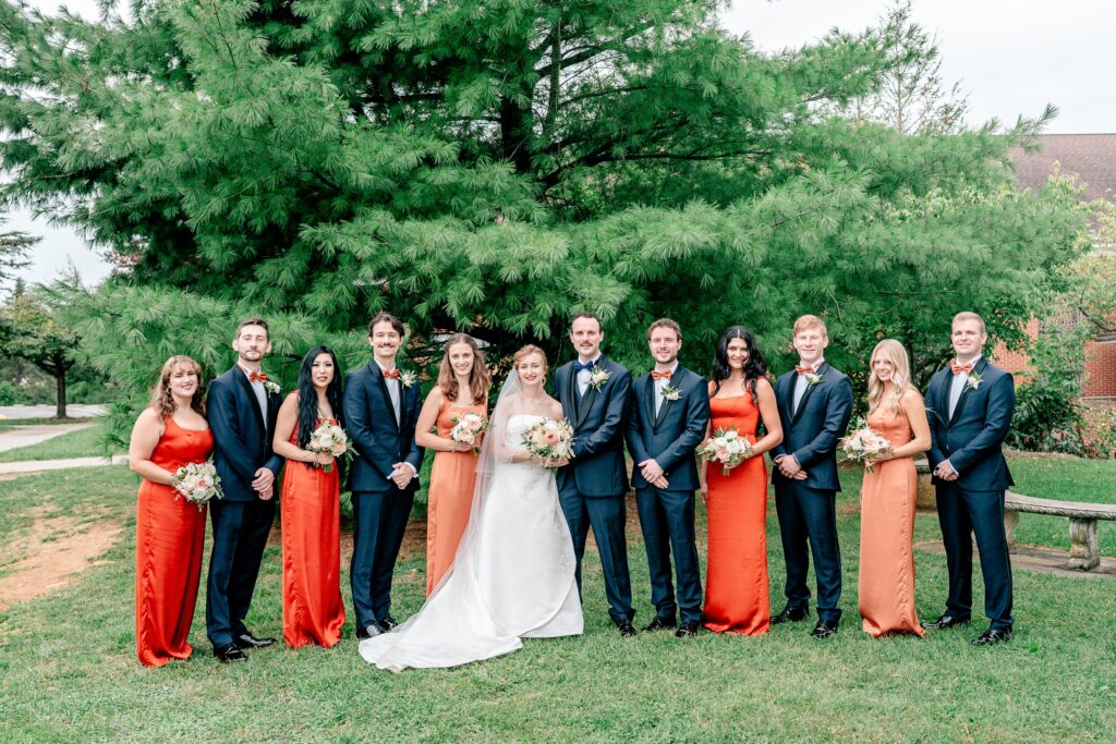 A wedding party poses for a classic portrait with their Catholic wedding photographer