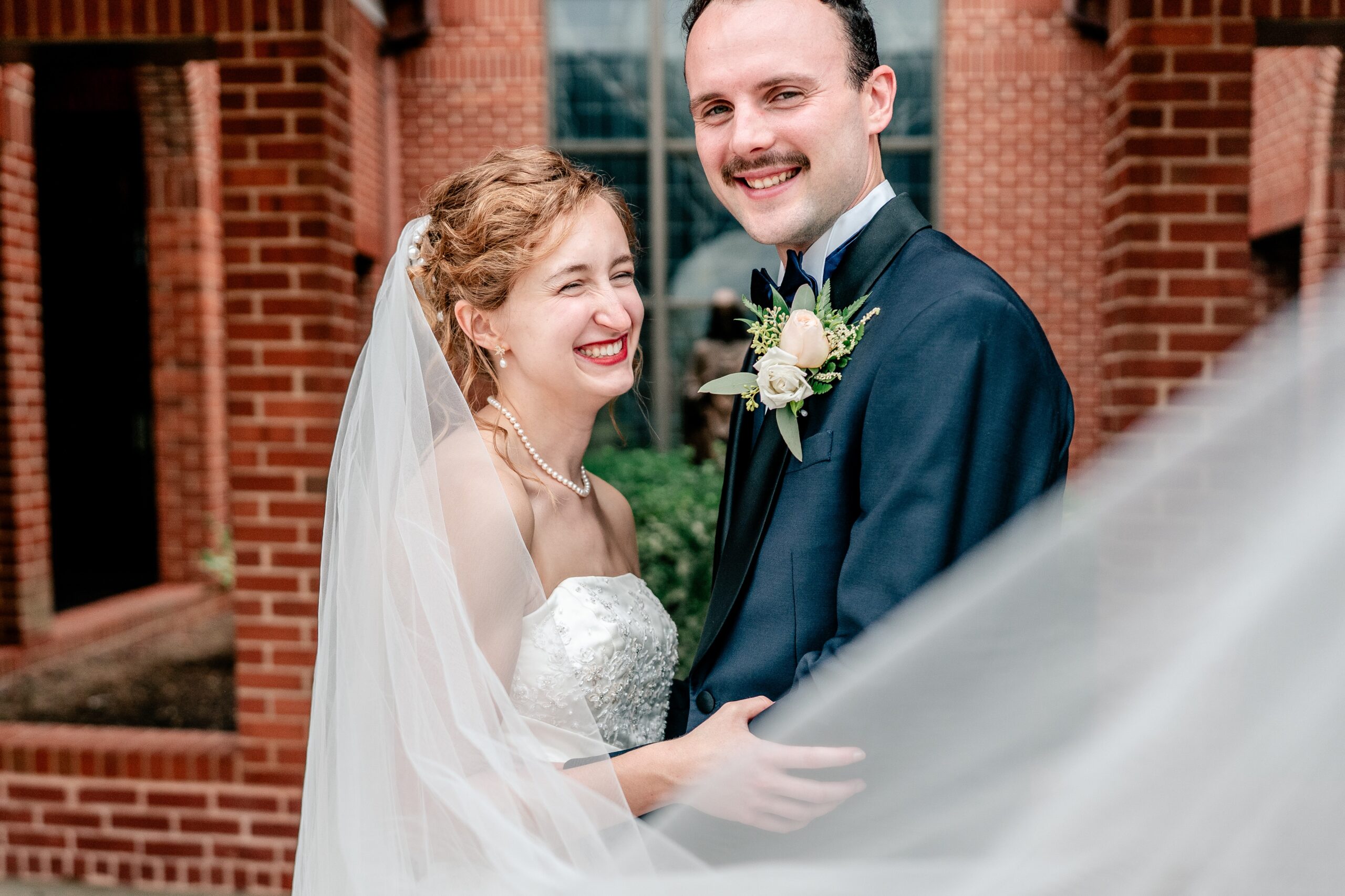 A bride and groom laughing together during their Winchester VA wedding