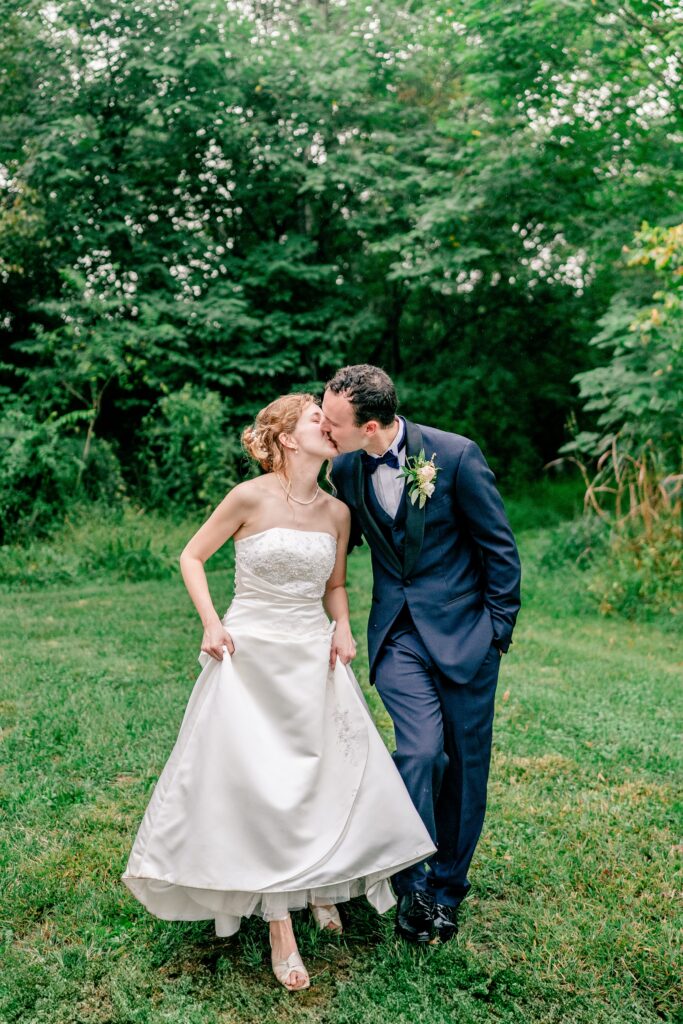 A bride and groom walk toward their Catholic wedding photographer