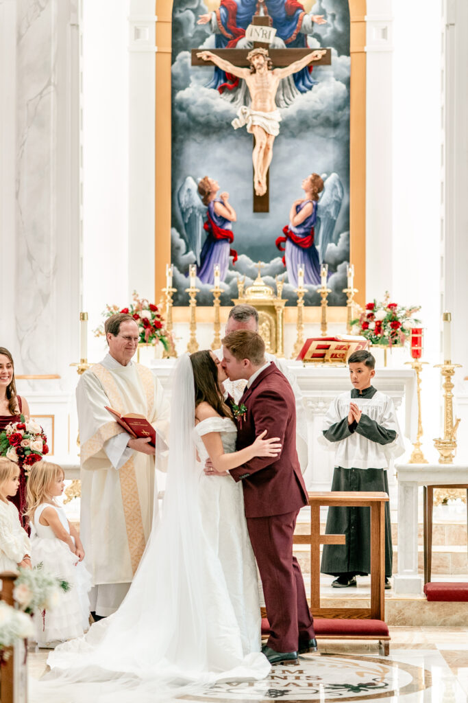 The first kiss as husband and wife for a St Francis de Sales wedding in Purcellville