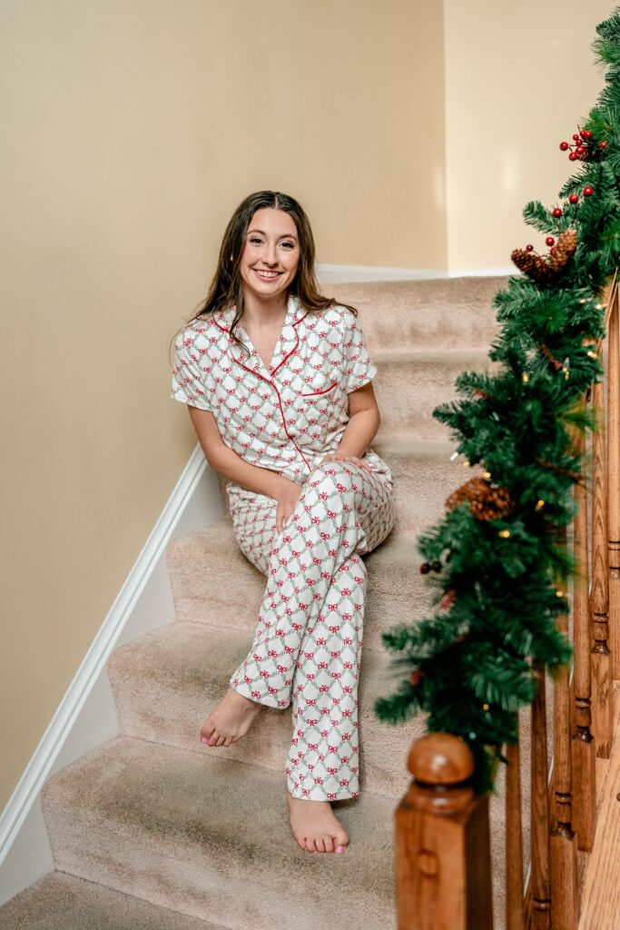 A bride smiling in Christmas pajamas before her Catholic wedding in Purcellville