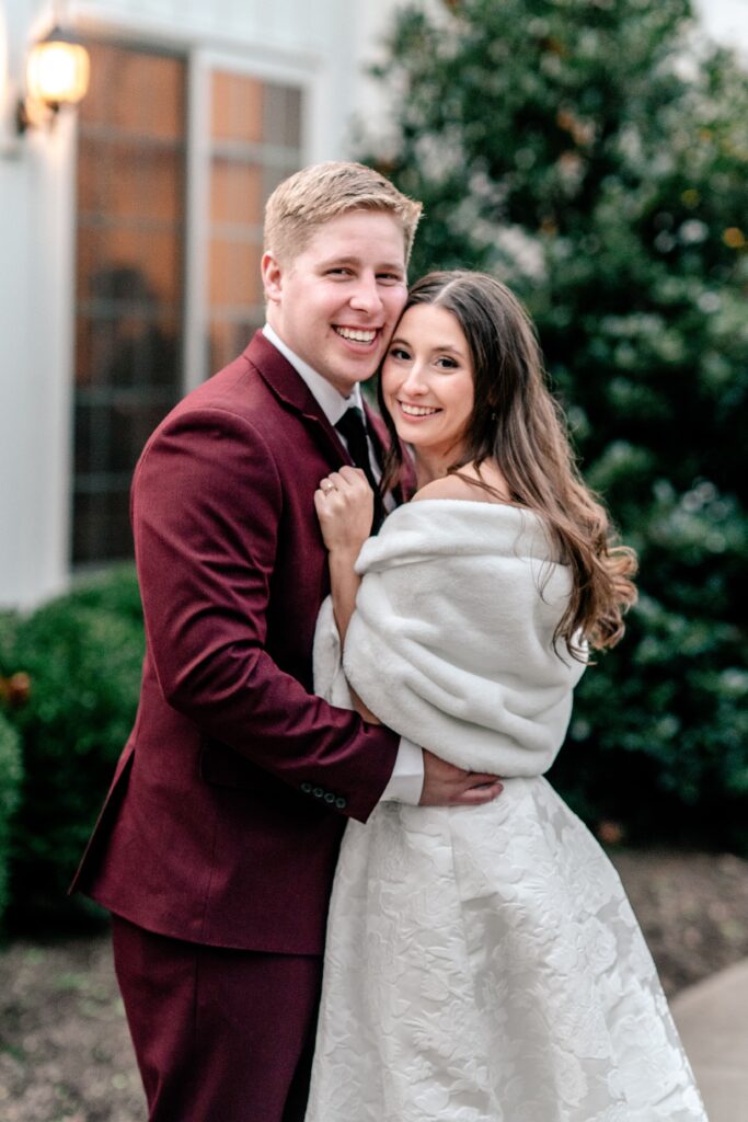 A bride and groom snuggled close for a winter wedding portrait