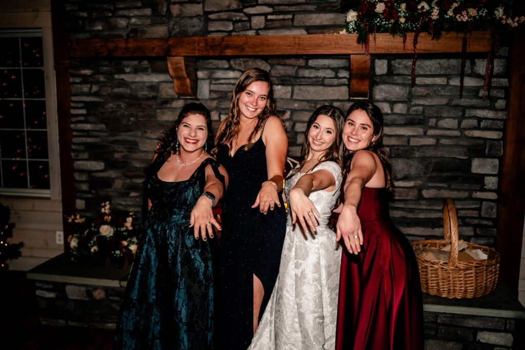 A bride and her friends posing with their wedding rings