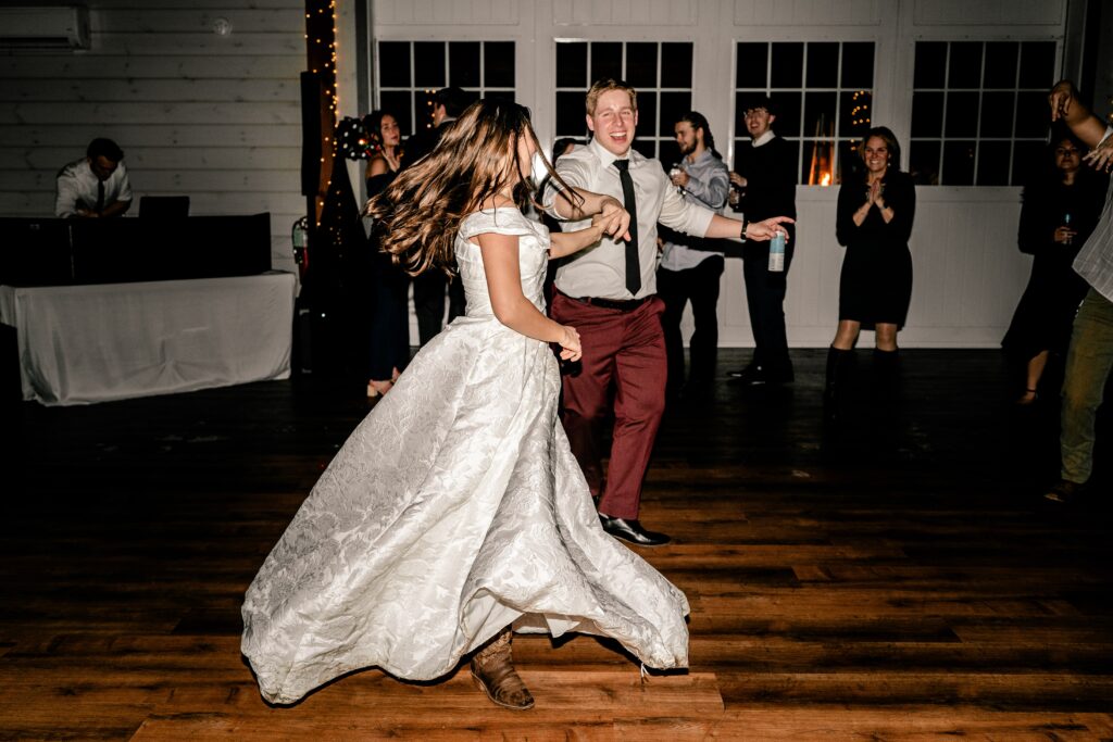 A groom twirling his bride during their Historic Rosemont wedding