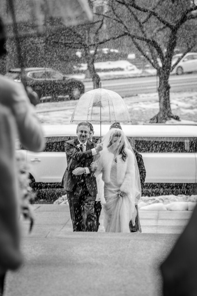 A bride and her father walking into the church for a winter wedding in DC