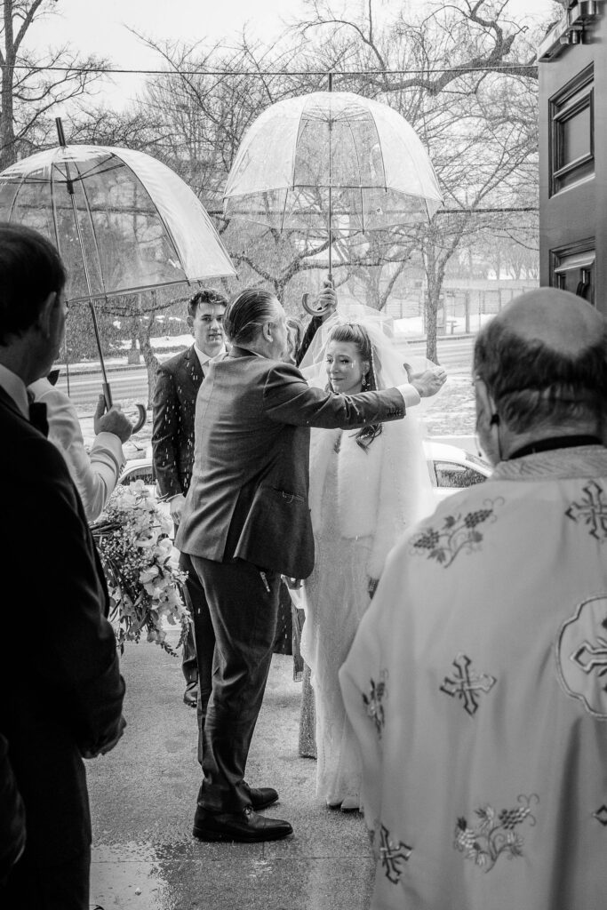 A groom lifting the bride's veil at the start of a Greek Orthodox wedding in Washington, DC