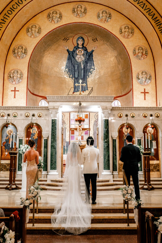 The bride and groom facing the Theotokos during their wedding