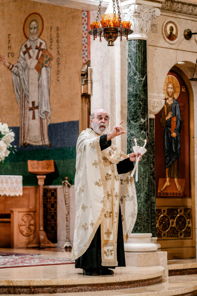 A Greek Orthodox priest speaking during a wedding ceremony