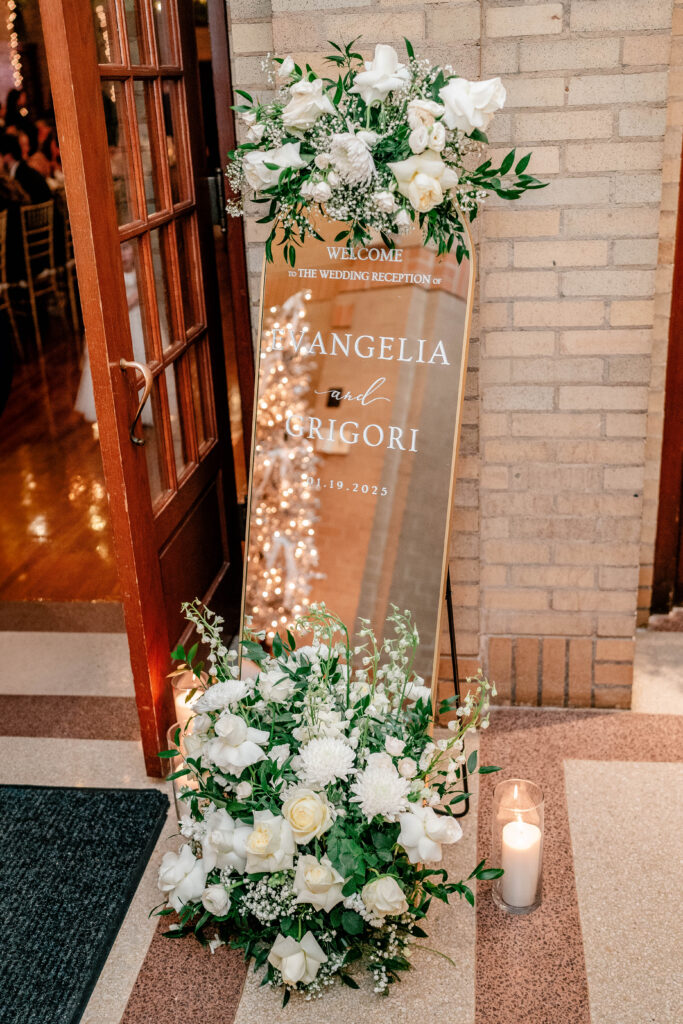 A welcome mirror decorated with white flowers