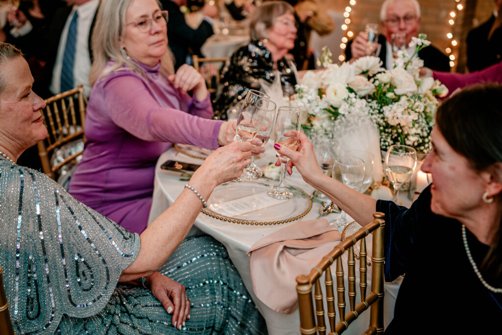 Guests toasting to the bride and groom