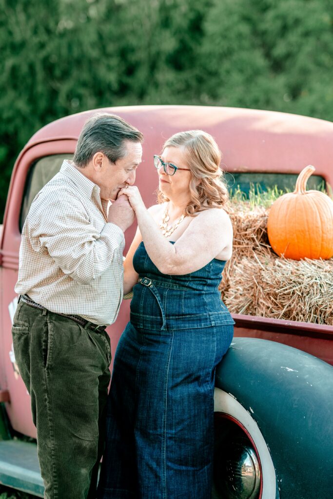 A man kissing the hand of his bride to be during their brewery engagement photos