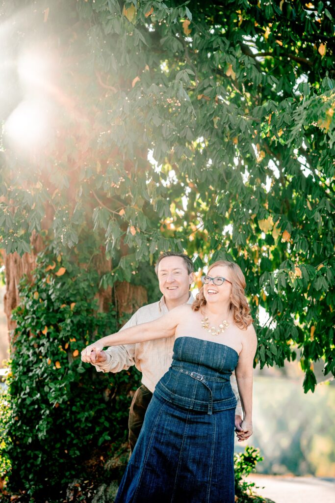 A couple laughing together as they hold hands
