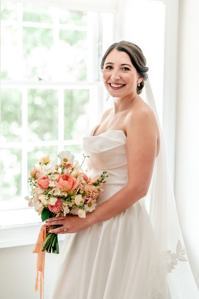 A bride posed by the window while getting ready for her Loudoun County wedding
