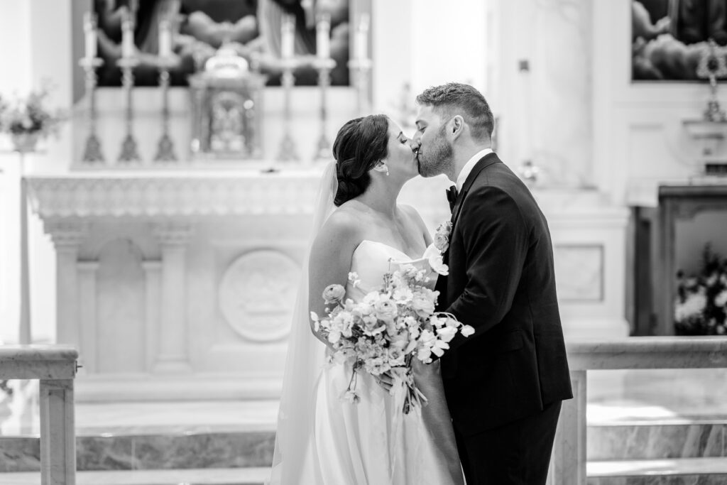 An intimate first kiss by the altar before a Shadow Creek wedding reception