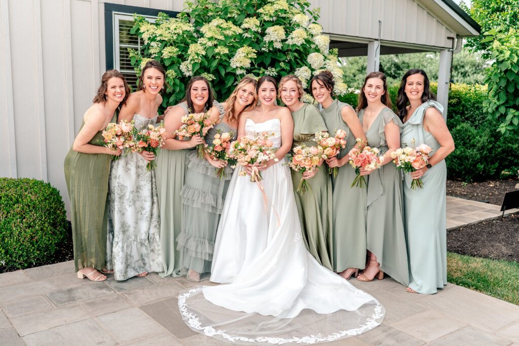 Bridesmaids in mismatched green dresses at a Loudoun County wedding