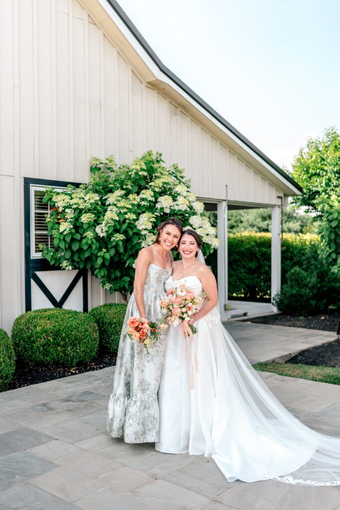A bride and her maid of honor posing for a classic portrait after a St. Francis de Sales wedding