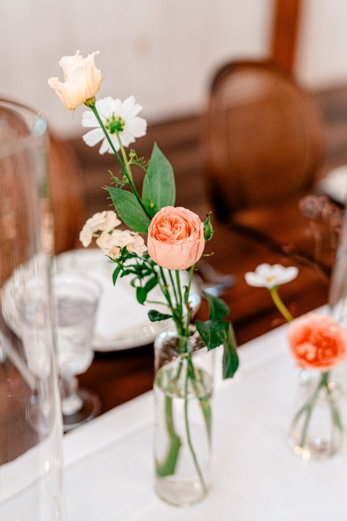 Bud vases with peachy summer florals for a Shadow Creek wedding
