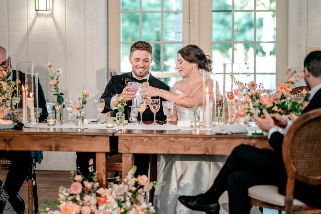 A bride and groom toasting from their head table at a Loudoun County wedding reception