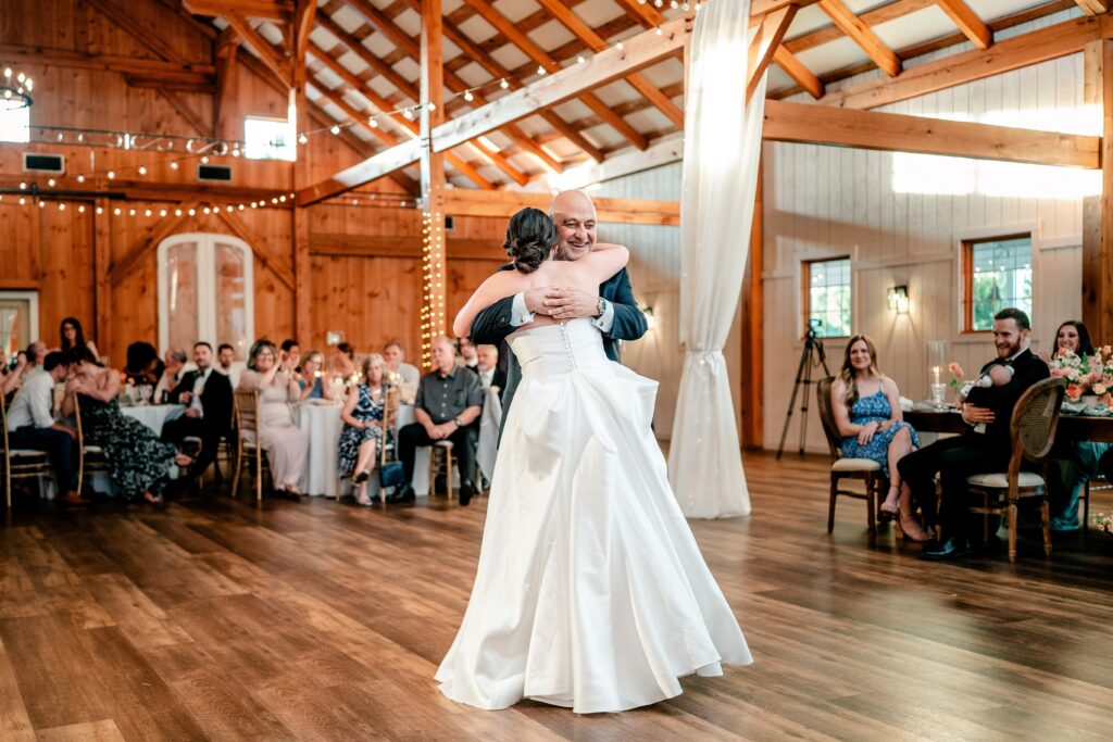 A bride and her dad dancing together during her barn wedding reception in Northern Virginia