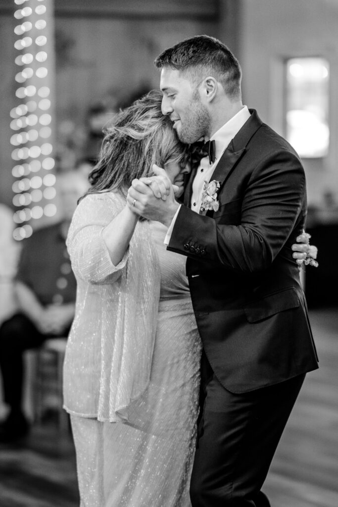 A groom and his mom dancing together