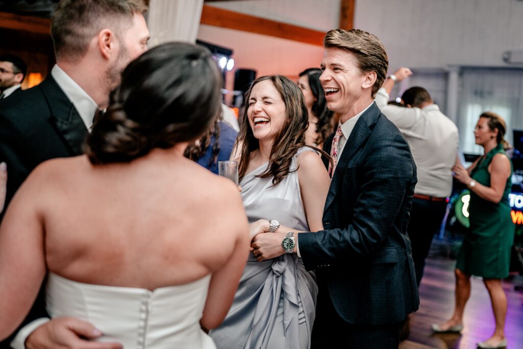Guests laughing with the bride and groom during a Shadow Creek wedding reception