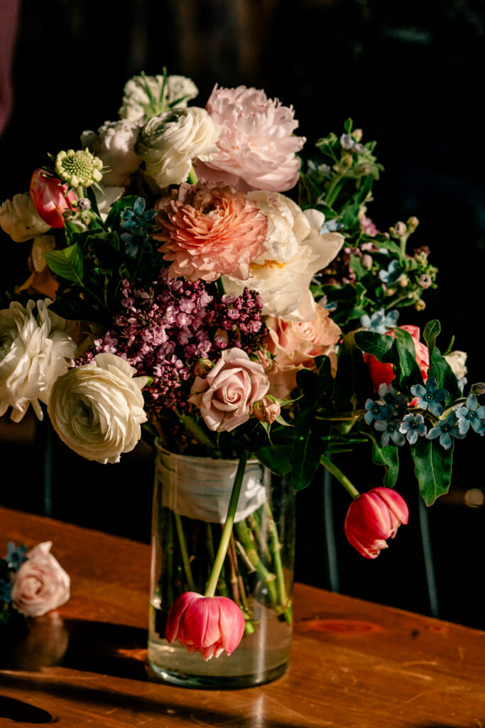 A colorful bouquet of flowers with two pink tulips drooping down low with a Northern VA wedding photographer