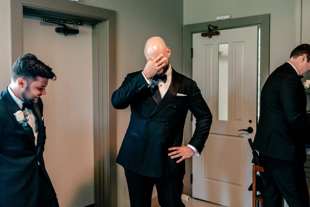 A groom getting emotional before his wedding at Corpus Christi Catholic Church in Aldie, VA