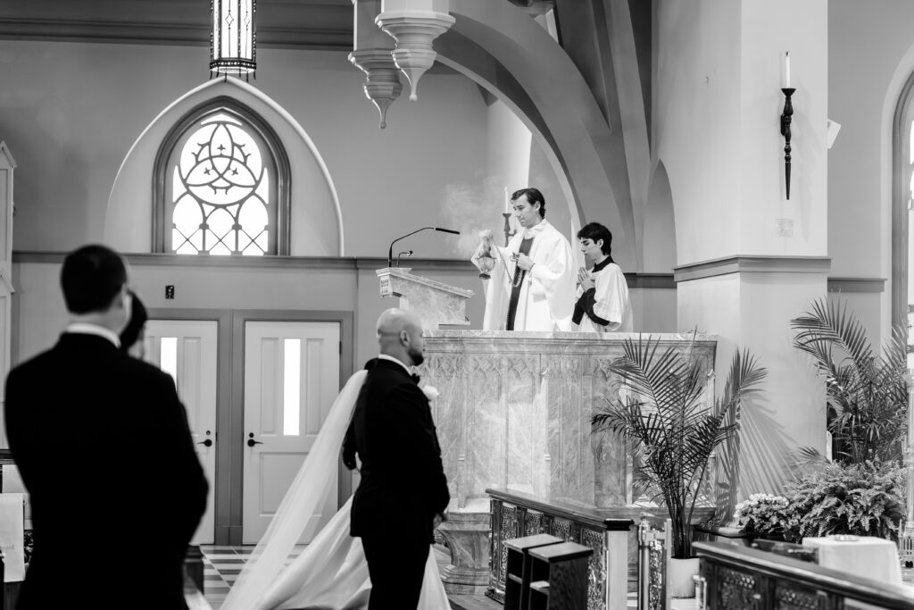 A priest using incense during a Catholic wedding