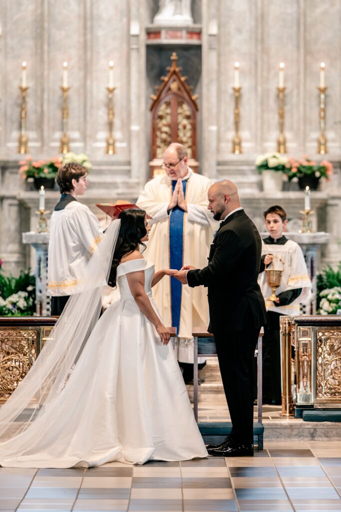 A groom placing the ring on his bride's finger during their Loudoun County wedding