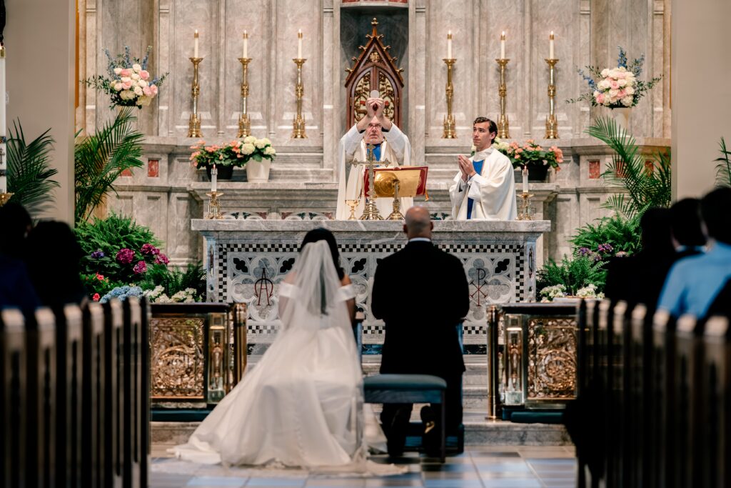 The moment of Consecration during a wedding at Corpus Christi Catholic Church in Aldie, VA