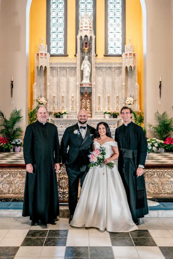 A bride and groom posed with their priests for a wedding at Corpus Christi Catholic Church in Aldie, VA