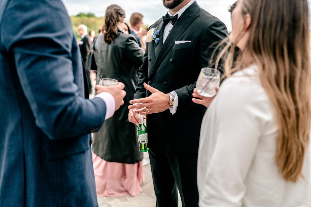 A groom gesturing with his hand sporting a new wedding ring during his Loudoun County wedding