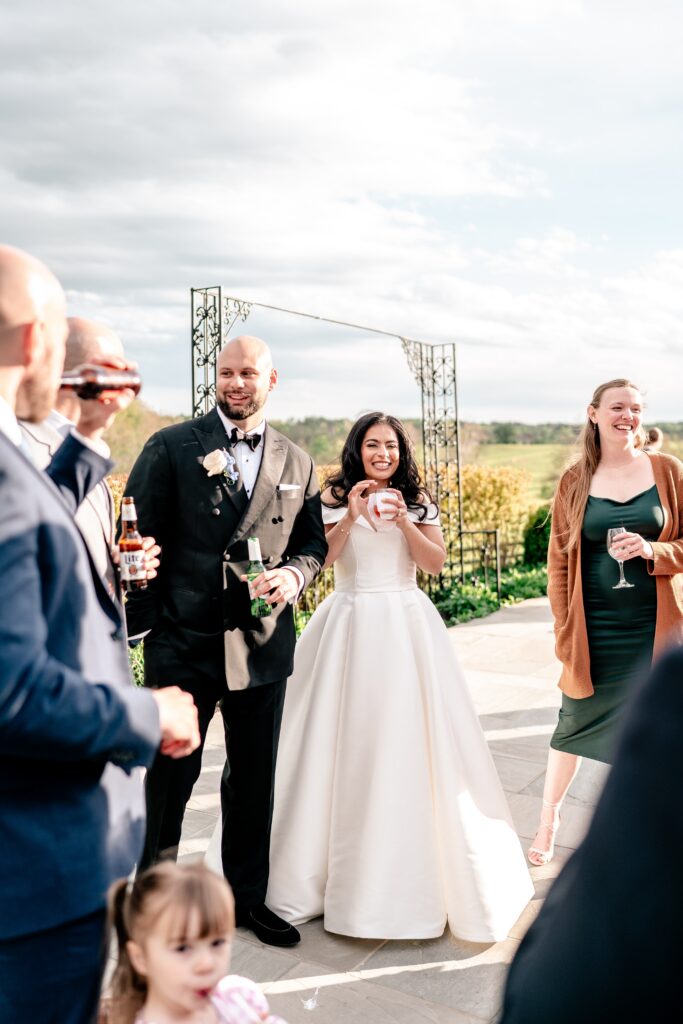 A bride and groom enjoying cocktail hour with their guests