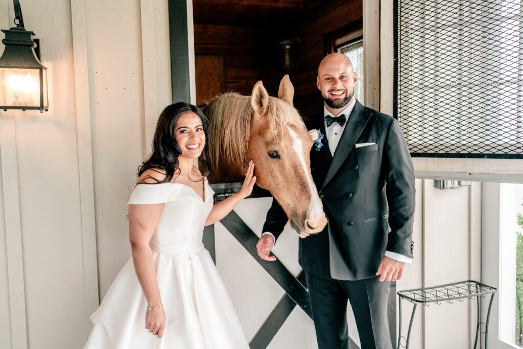 A bride and groom posed with a horse for their Loudoun County wedding