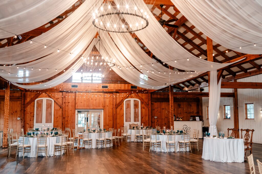 A barn reception in Northern VA with white draping and blue accents