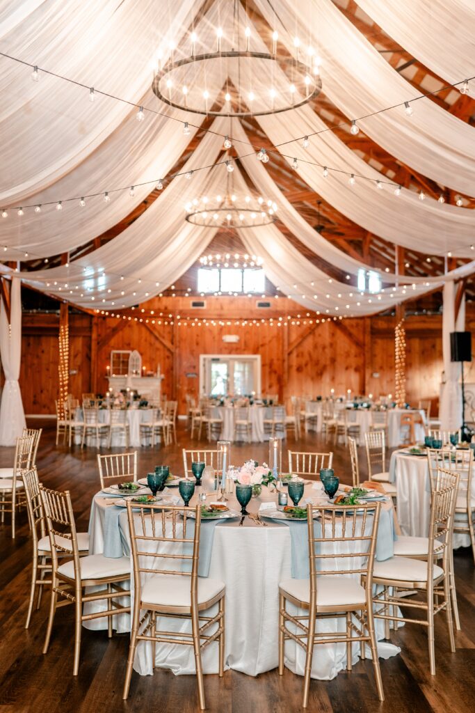 A barn reception featuring blue details and white drapery for a Loudoun County wedding