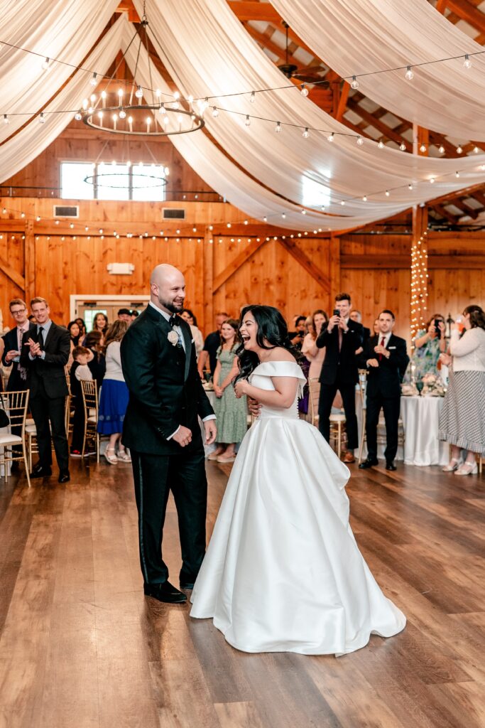 A bride and groom laughing during their introductions at a Shadow Creek wedding