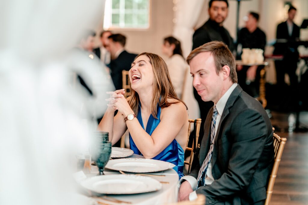 Wedding guests laughing during dinner