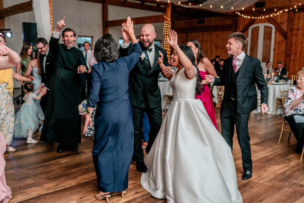 A groom giving his mom a high five during their Shadow Creek wedding