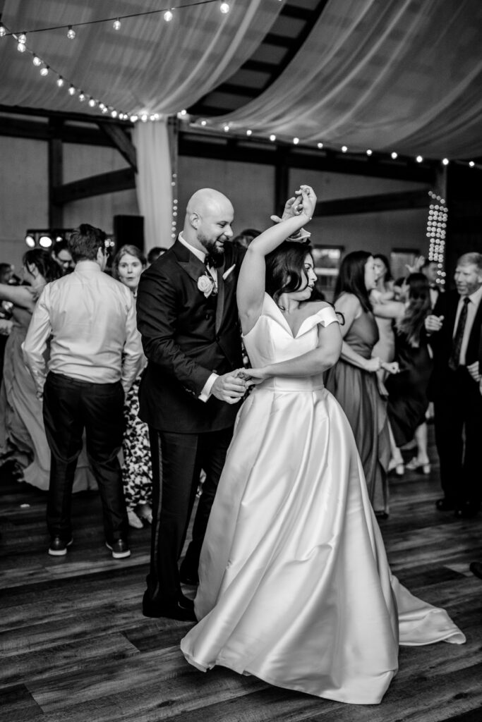 A groom twirling his bride at their Loudoun County wedding reception
